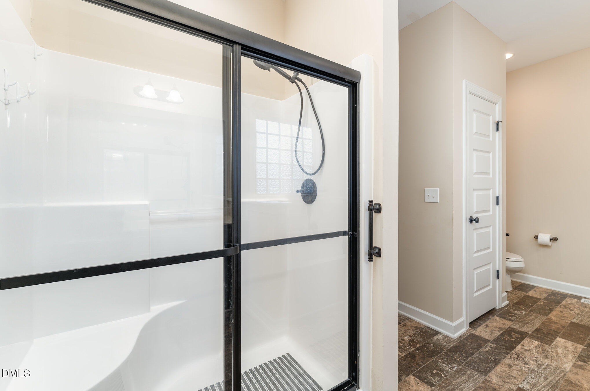 410 Penwood Road Willow Spring, NC 27592 - Photo 15 of 21 a bathroom with a glass shower door