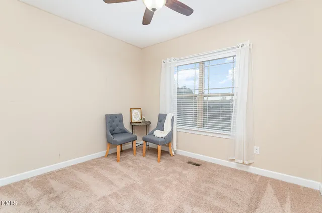 a view of a room with windows and lounge chair