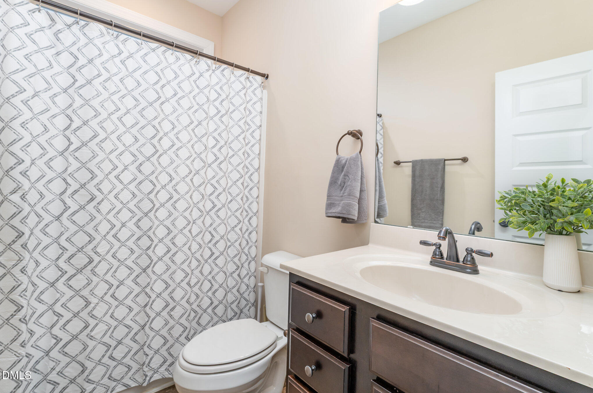 410 Penwood Road Willow Spring, NC 27592 - Photo 17 of 21 a bathroom with a sink and a mirror