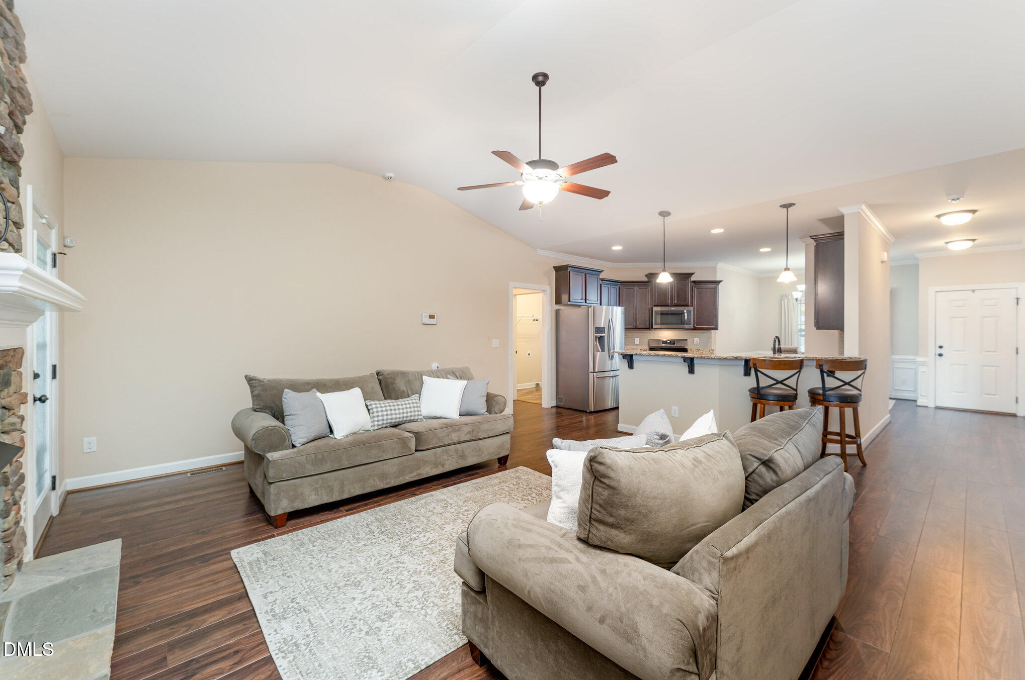 410 Penwood Road Willow Spring, NC 27592 - Photo 9 of 21 a living room with furniture kitchen view and a chandelier