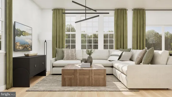 a living room with furniture and large windows