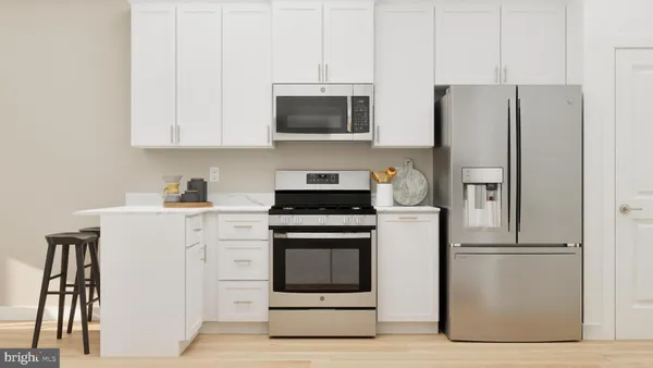 a kitchen with stainless steel appliances a stove a microwave and a refrigerator
