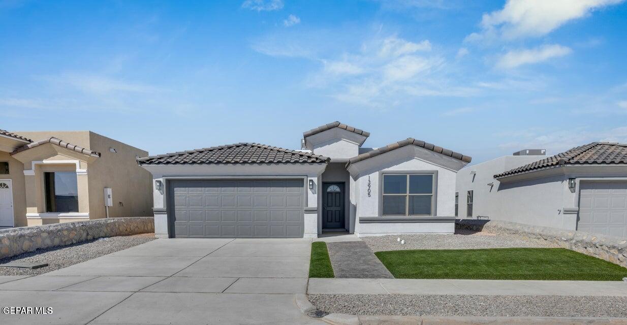 a front view of a house with a yard and garage