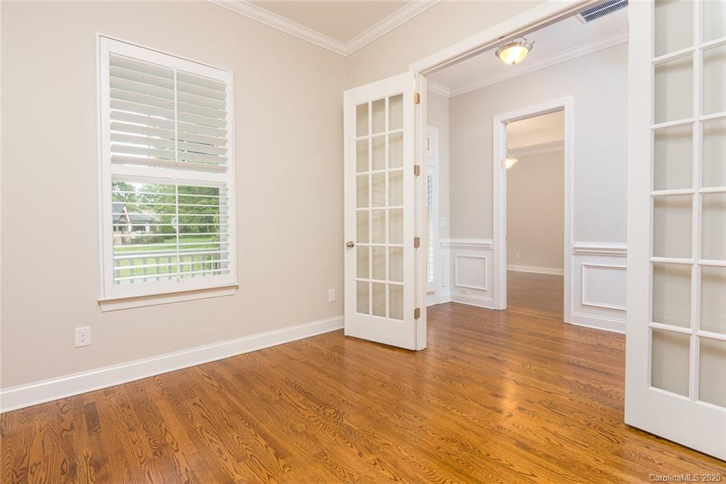 4736 Water Oak Road Charlotte, NC 28211 - Photo 14 of 45 a view of an empty room with wooden floor and a window