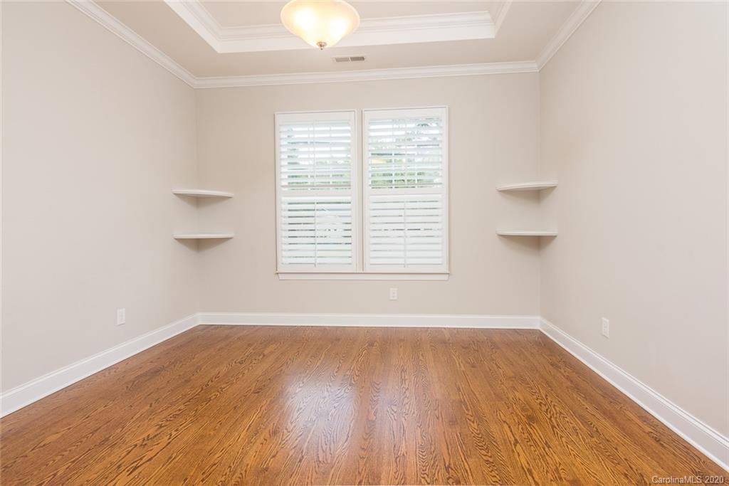 4736 Water Oak Road Charlotte, NC 28211 - Photo 17 of 45 an empty room with wooden floor and windows