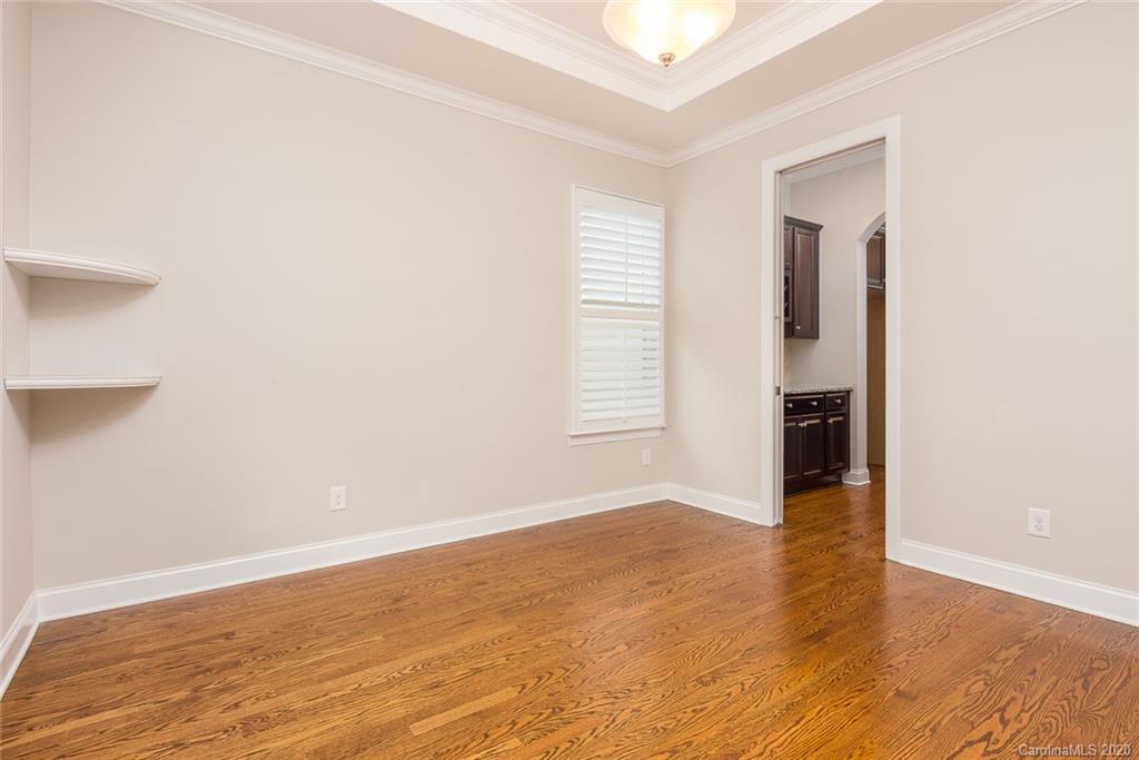 4736 Water Oak Road Charlotte, NC 28211 - Photo 18 of 45 an empty room with wooden floor and windows