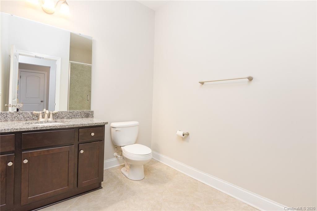 4736 Water Oak Road Charlotte, NC 28211 - Photo 24 of 45 a bathroom with a granite countertop sink a toilet and a mirror