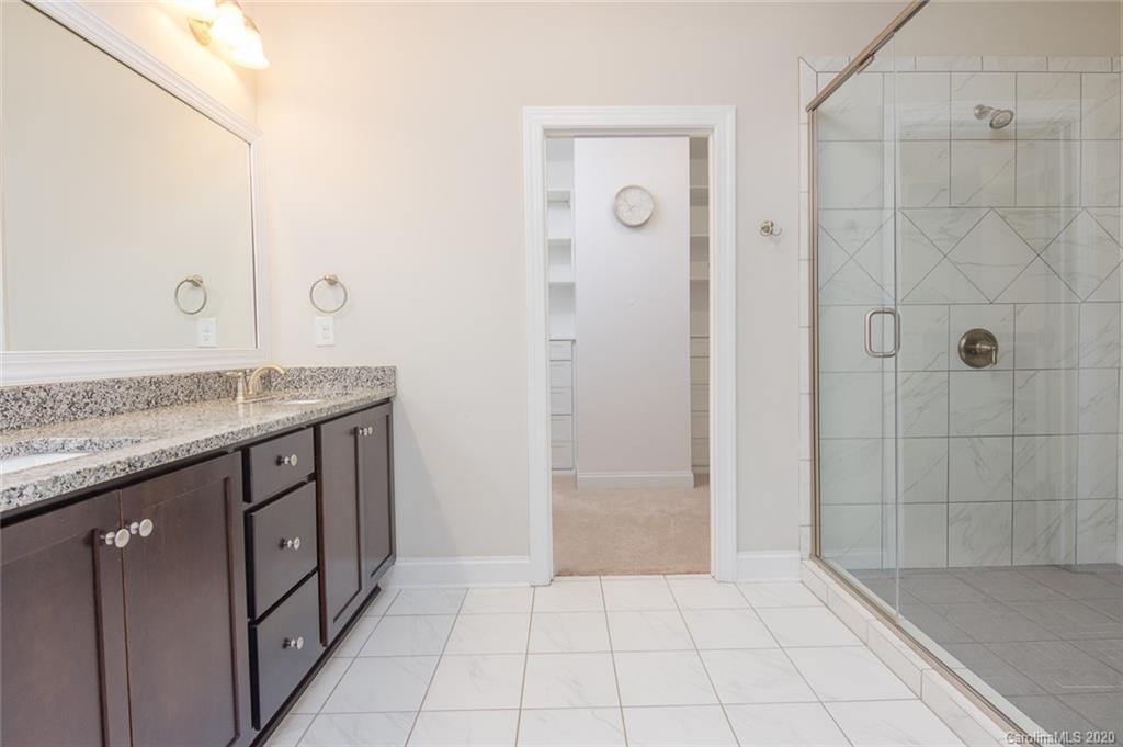 4736 Water Oak Road Charlotte, NC 28211 - Photo 28 of 45 a bathroom with a granite countertop sink a mirror and shower