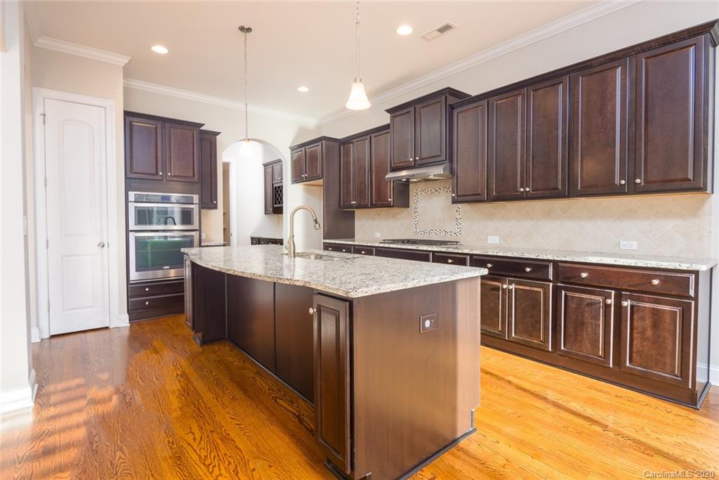 4736 Water Oak Road Charlotte, NC 28211 - Photo 4 of 45 a kitchen with stainless steel appliances granite countertop a stove a sink dishwasher and a refrigerator with wooden floor