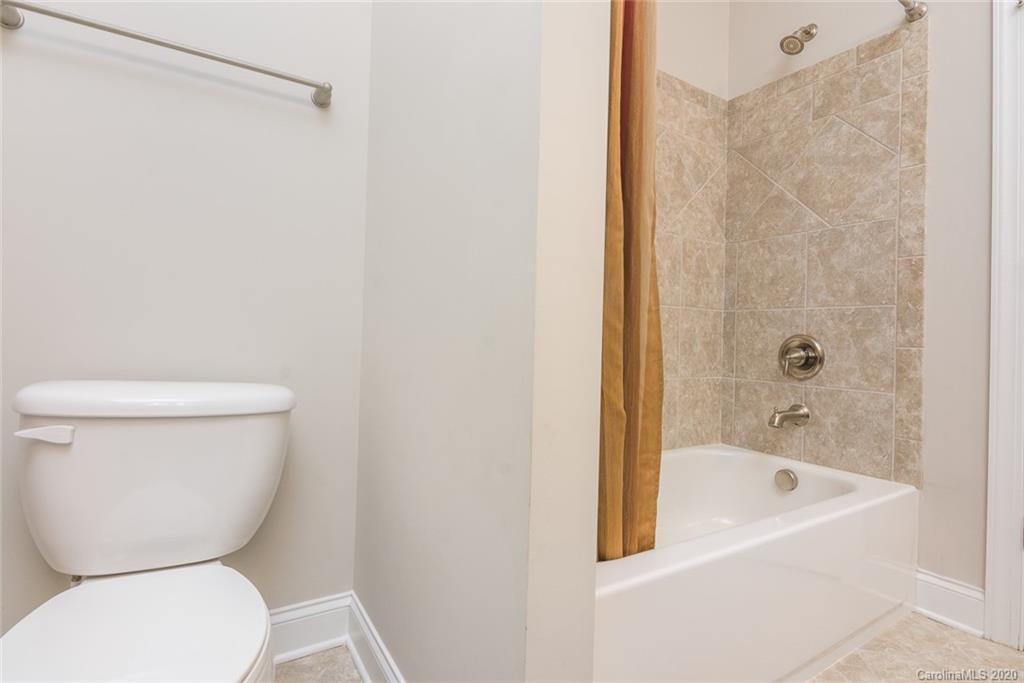 4736 Water Oak Road Charlotte, NC 28211 - Photo 32 of 45 a bathroom with a toilet and a bathtub