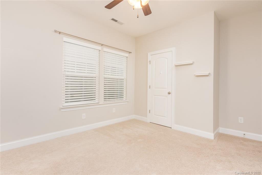 4736 Water Oak Road Charlotte, NC 28211 - Photo 37 of 45 an empty room with a window and a fan