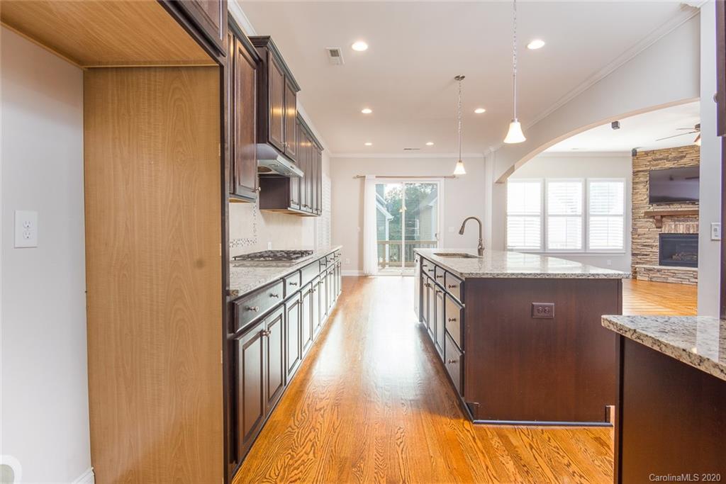 4736 Water Oak Road Charlotte, NC 28211 - Photo 6 of 45 a kitchen with kitchen island granite countertop a large counter top space a sink stainless steel appliances and windows
