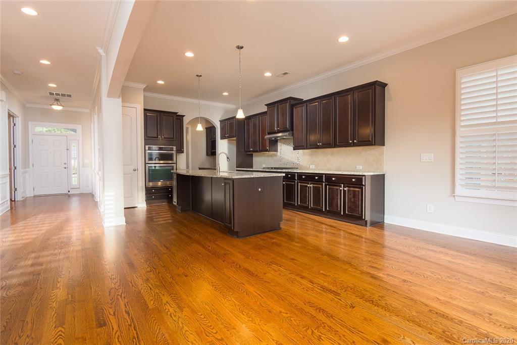 4736 Water Oak Road Charlotte, NC 28211 - Photo 7 of 45 a large kitchen with stainless steel appliances granite countertop a large counter top a wooden floors and a large window