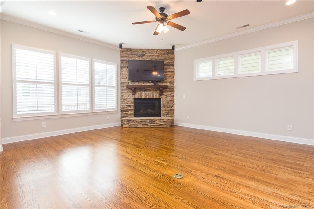 4736 Water Oak Road Charlotte, NC 28211 - Photo 9 of 45 a view of an empty room with a window and wooden floor