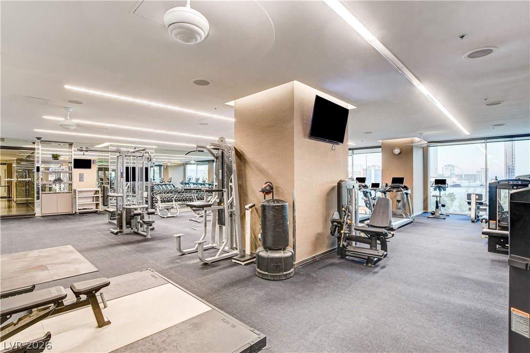 4381 West Flamingo Road, Unit 3002 Las Vegas, NV 89103 - Photo 27 of 59 Floor-to-ceiling windows fill the spacious fitness facility with abundant natural light.