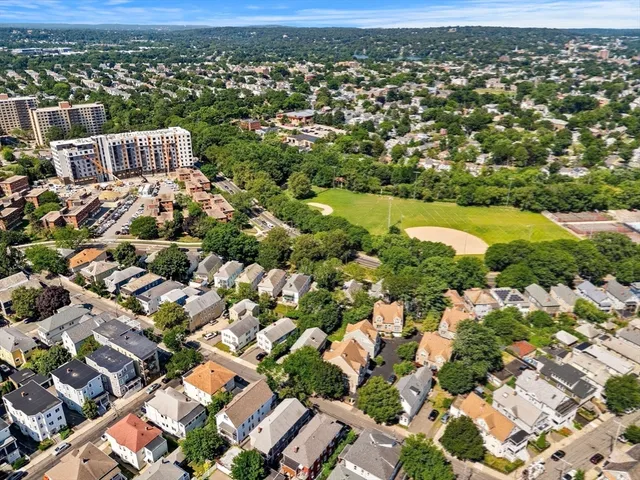 an aerial view of residential houses with city view