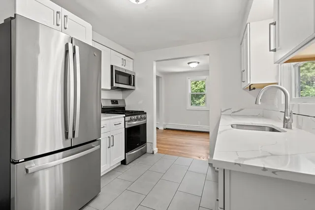 a kitchen with stainless steel appliances a refrigerator sink and stove
