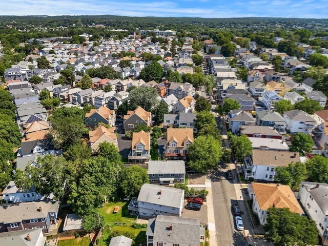 an aerial view of a houses with a yard