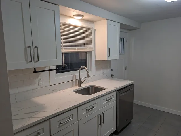 a kitchen with a sink and cabinets