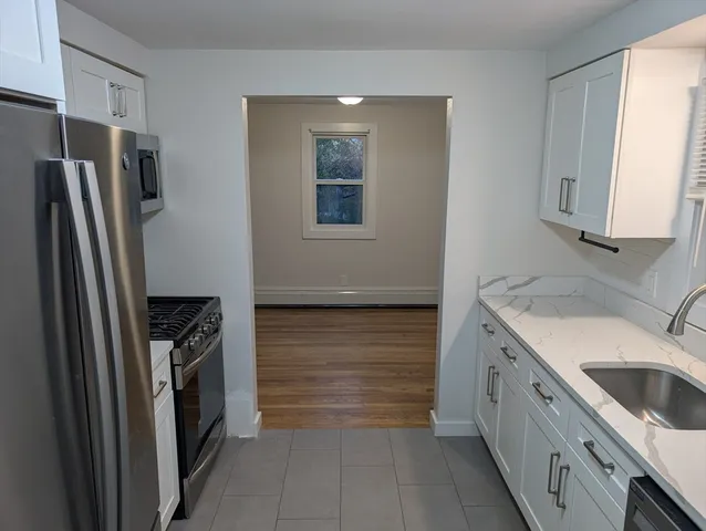 a kitchen with a refrigerator sink and stove