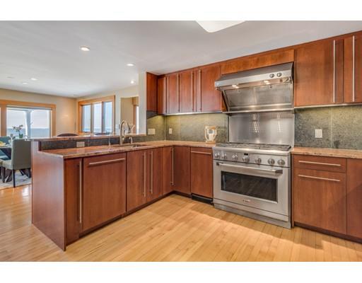 26 Rowley Shore Gloucester, MA 01930 - Photo 7 of 18 a kitchen with stainless steel appliances granite countertop a stove a sink dishwasher and a refrigerator