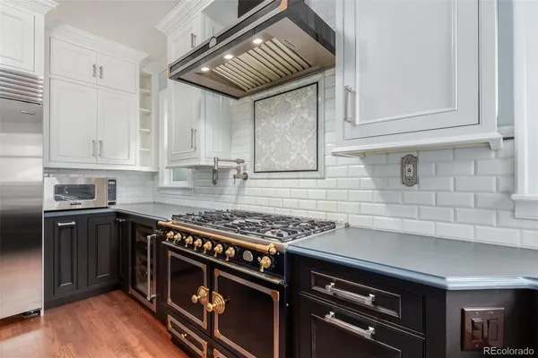 a kitchen with stainless steel appliances granite countertop a stove and a cabinets