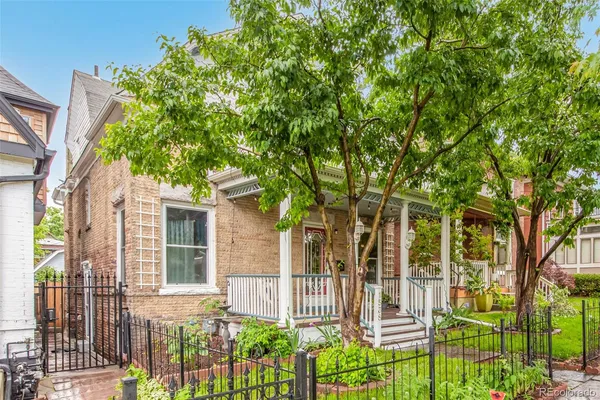 front view of a house with a tree