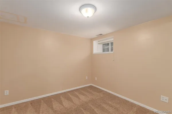an empty room with a empty space and a window