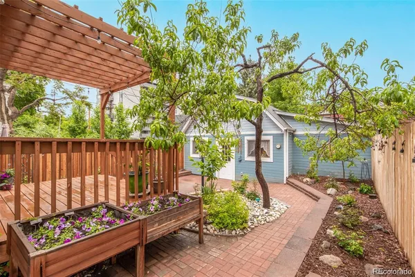 a view of a backyard with a wooden fence