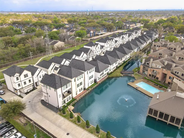 an aerial view of residential houses with outdoor space