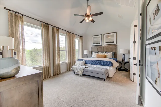 a bedroom with furniture and a large window