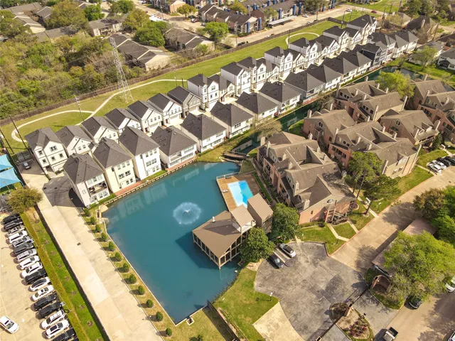 an aerial view of a residential building with parking
