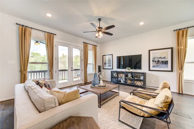 a living room with furniture tv and a large window
