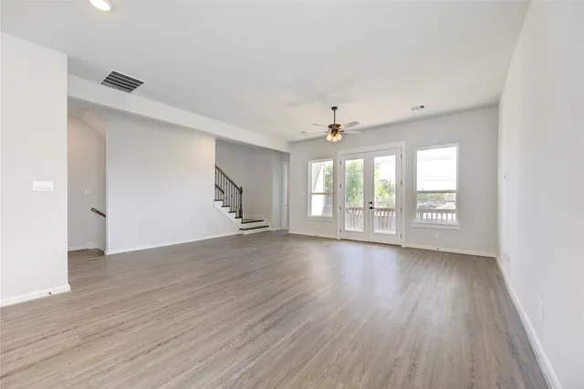 a living room with furniture a flat screen tv and a large window