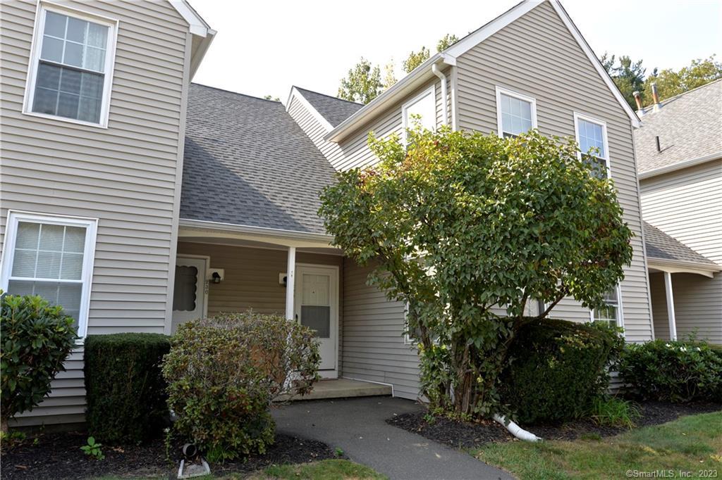 229 Branford Road, Unit 229 North Branford, CT 06471 - Photo 1 of 1 a view of a house with a yard and plants