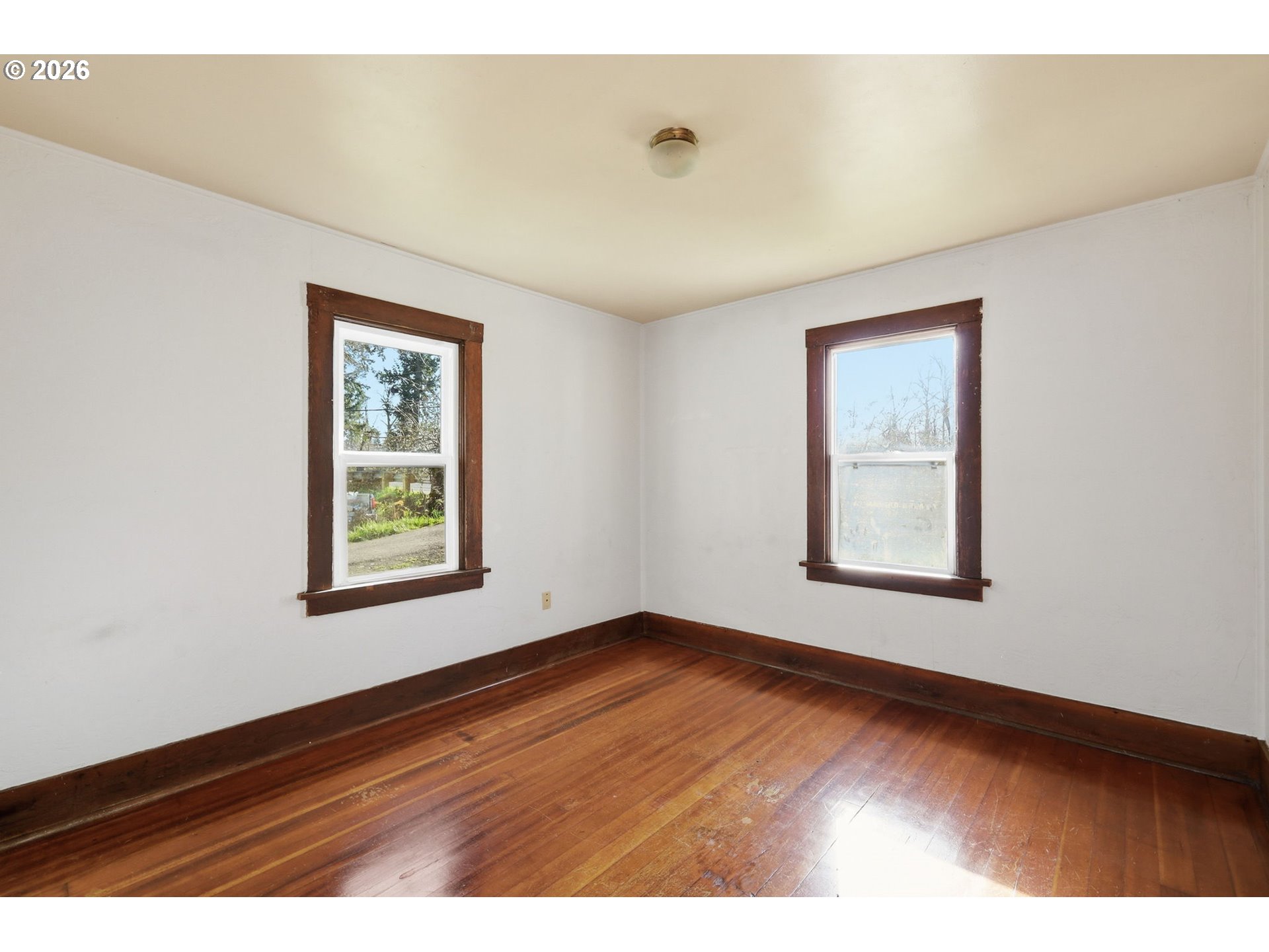 36725 Jasper Road Springfield, OR 97478 - Photo 11 of 46 an empty room with wooden floor and windows