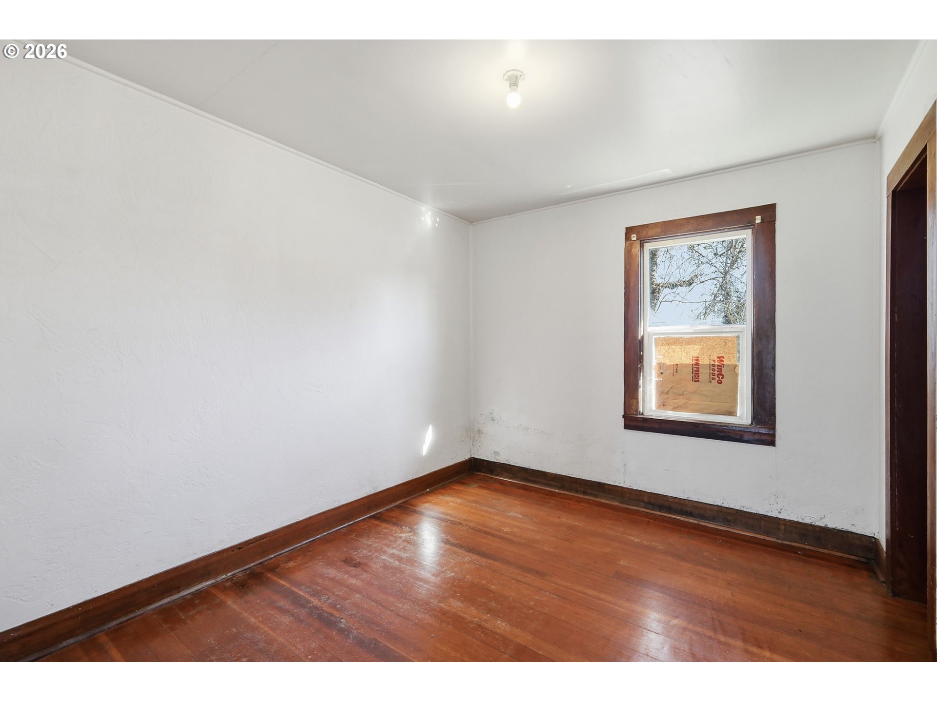 36725 Jasper Road Springfield, OR 97478 - Photo 14 of 46 a view of an empty room with wooden floor and a window
