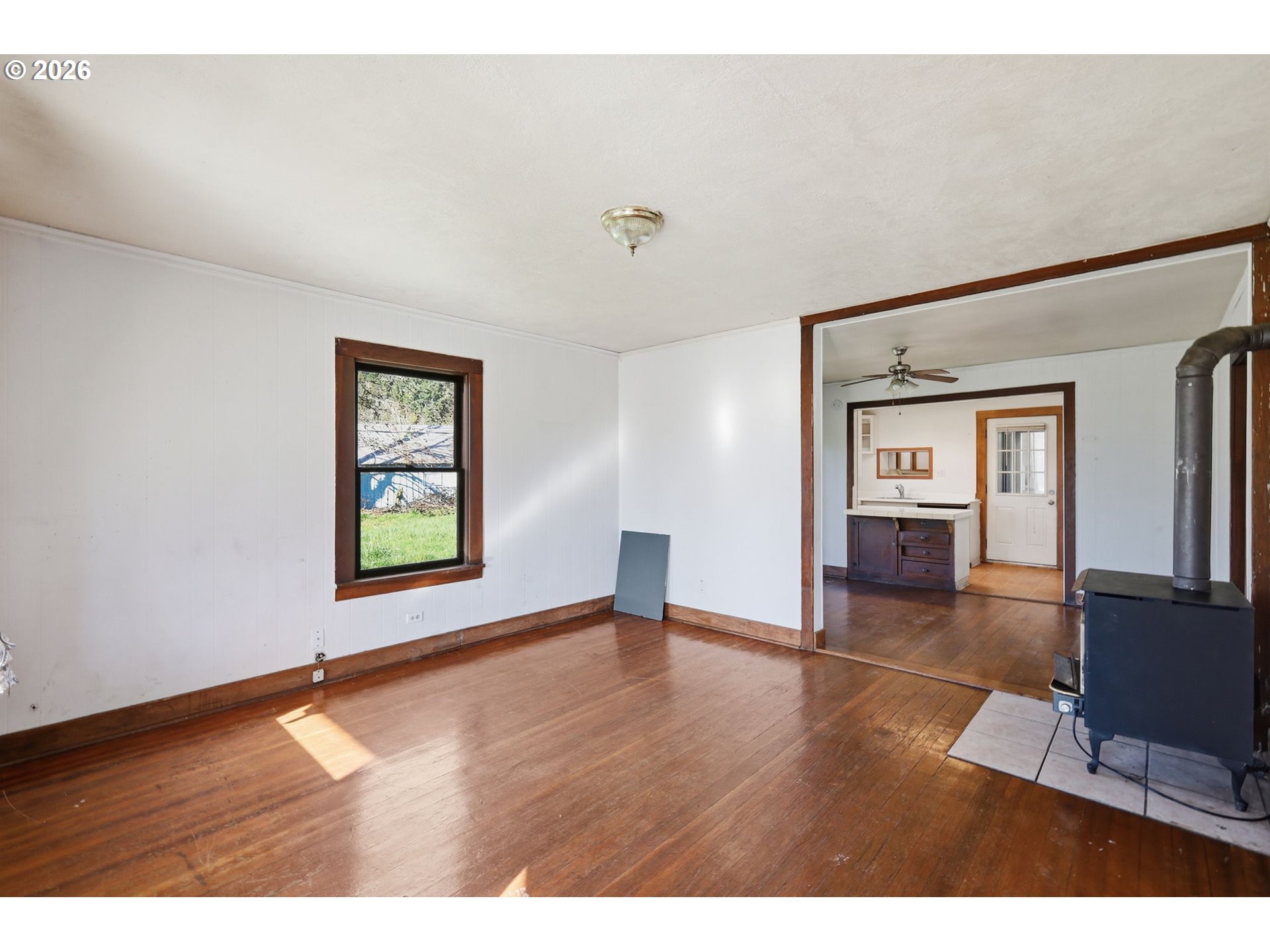 36725 Jasper Road Springfield, OR 97478 - Photo 7 of 46 a view of an empty room with window and wooden floor