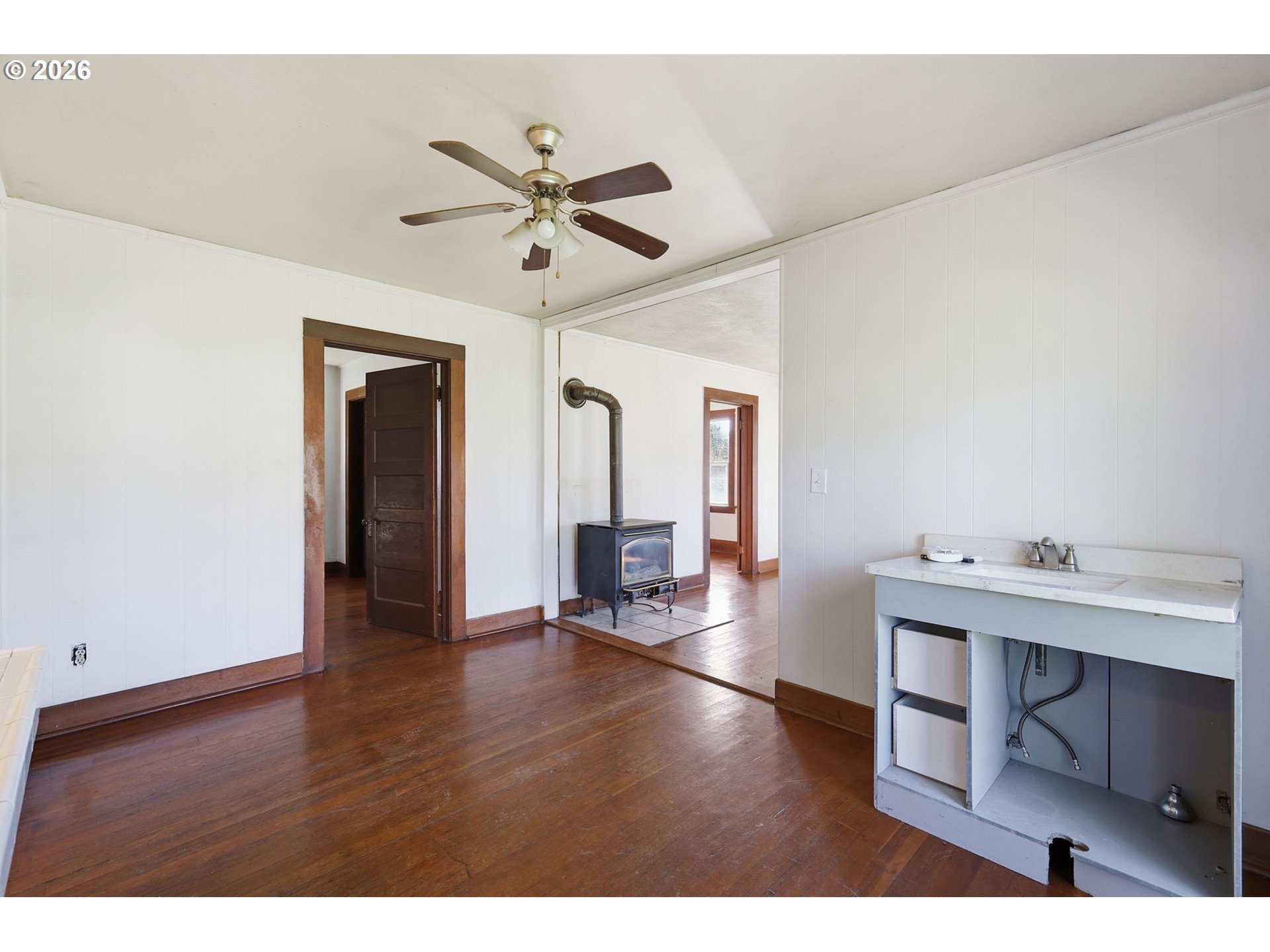 36725 Jasper Road Springfield, OR 97478 - Photo 9 of 46 a view of a livingroom with a furniture hardwood floor and a ceiling fan