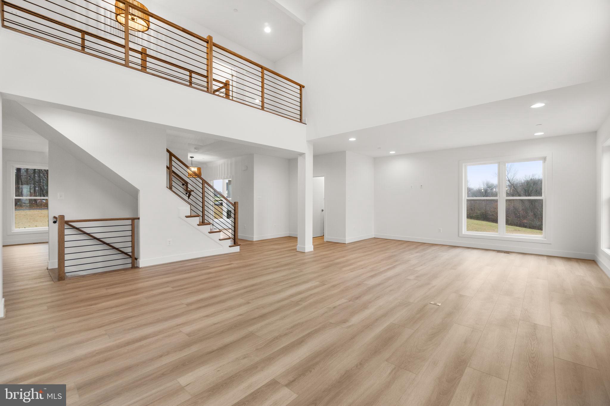 14628 Old Hanover Road, Unit BENTON Reisterstown, MD 21136 - Photo 12 of 69 a view of an empty room with wooden floor and a window