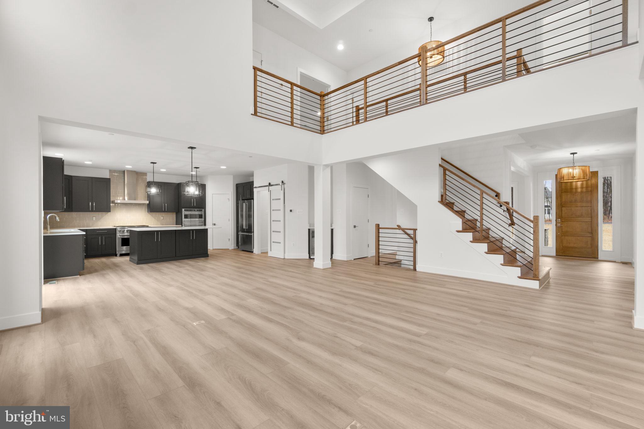 14628 Old Hanover Road, Unit BENTON Reisterstown, MD 21136 - Photo 13 of 69 a view of an empty room and kitchen view with wooden floor