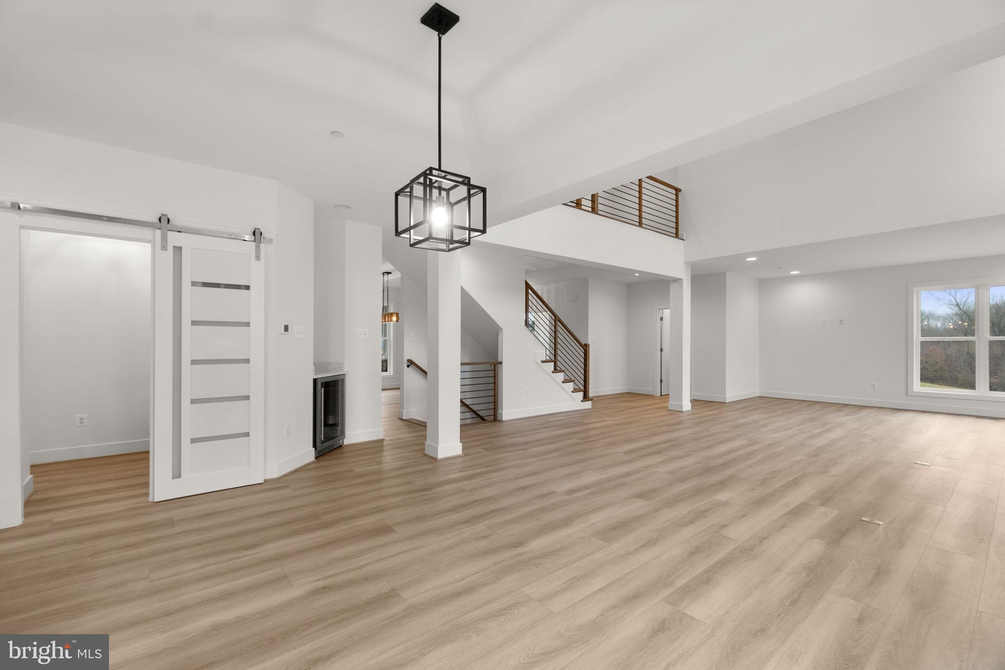 14628 Old Hanover Road, Unit BENTON Reisterstown, MD 21136 - Photo 16 of 69 a view of empty room with wooden floor entryway and windows