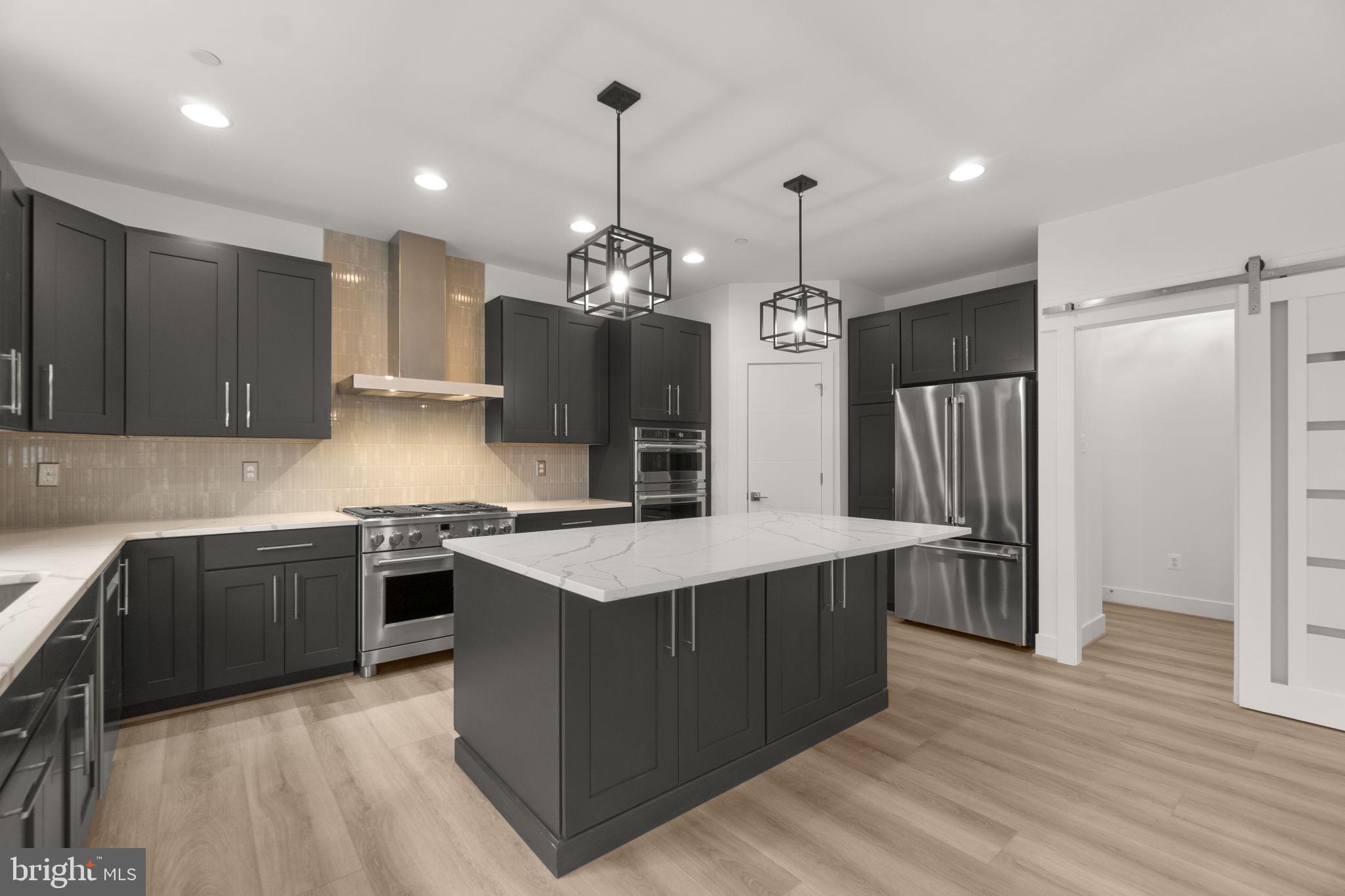 14628 Old Hanover Road, Unit BENTON Reisterstown, MD 21136 - Photo 17 of 69 a kitchen with stainless steel appliances granite countertop a sink a stove and a refrigerator