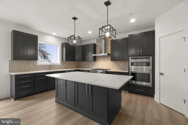 a kitchen with granite countertop stainless steel appliances and wooden cabinets