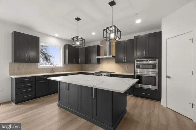 a kitchen with granite countertop stainless steel appliances and wooden cabinets
