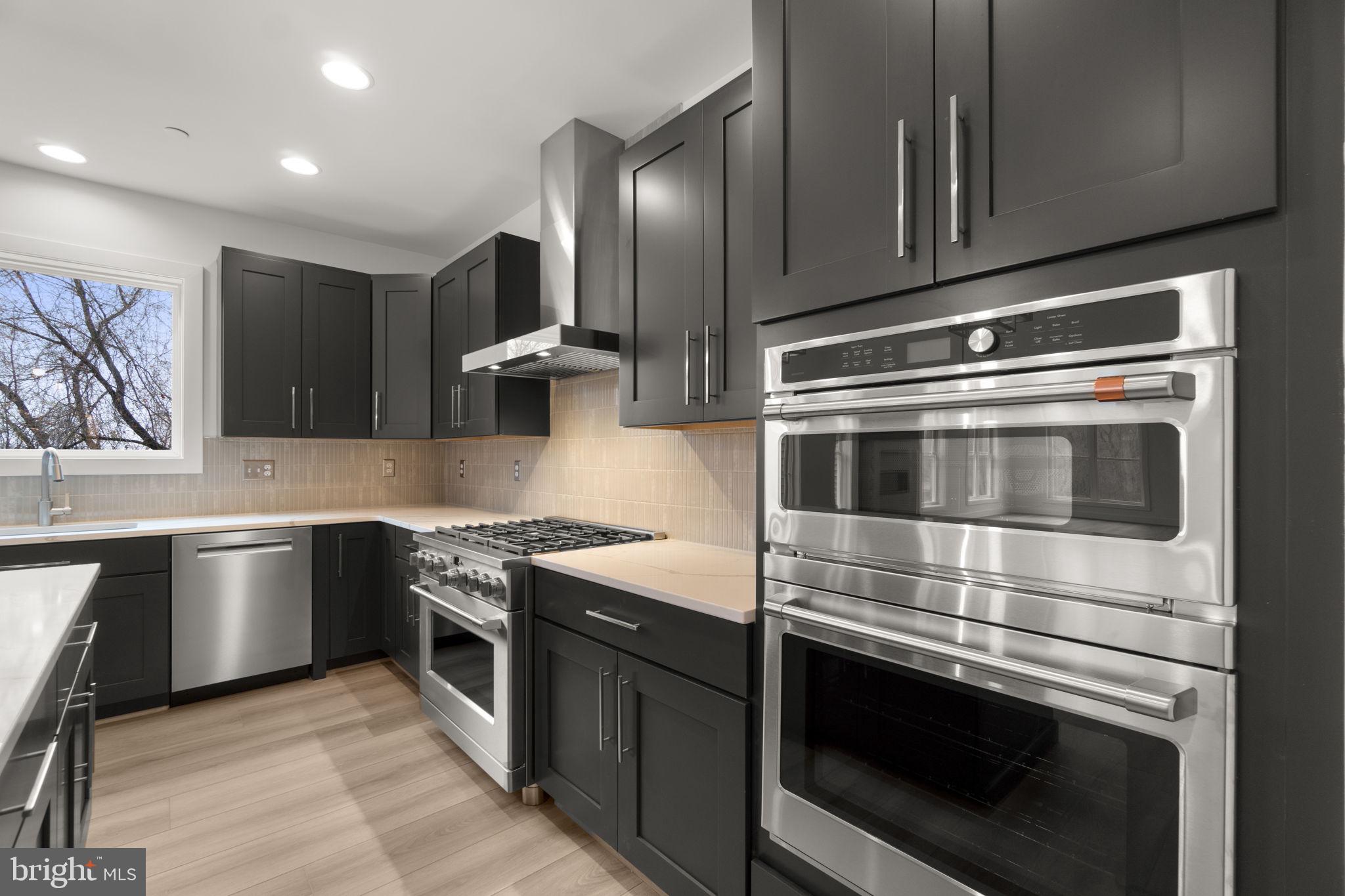 14628 Old Hanover Road, Unit BENTON Reisterstown, MD 21136 - Photo 20 of 69 a kitchen with granite countertop stainless steel appliances and wooden cabinets
