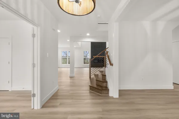 a view of entryway and hall with wooden floor