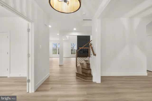 a view of entryway and hall with wooden floor