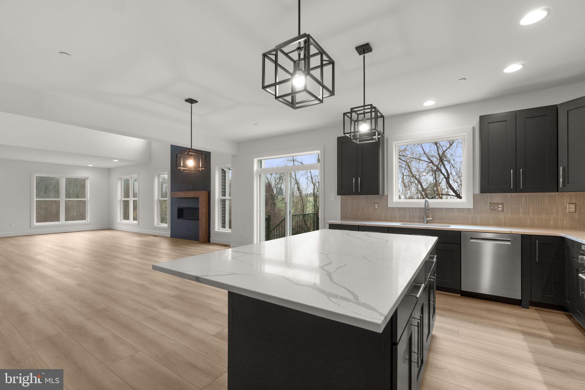 14628 Old Hanover Road, Unit BENTON Reisterstown, MD 21136 - Photo 21 of 69 a kitchen with stainless steel appliances granite countertop a kitchen island a stove and a wooden floors
