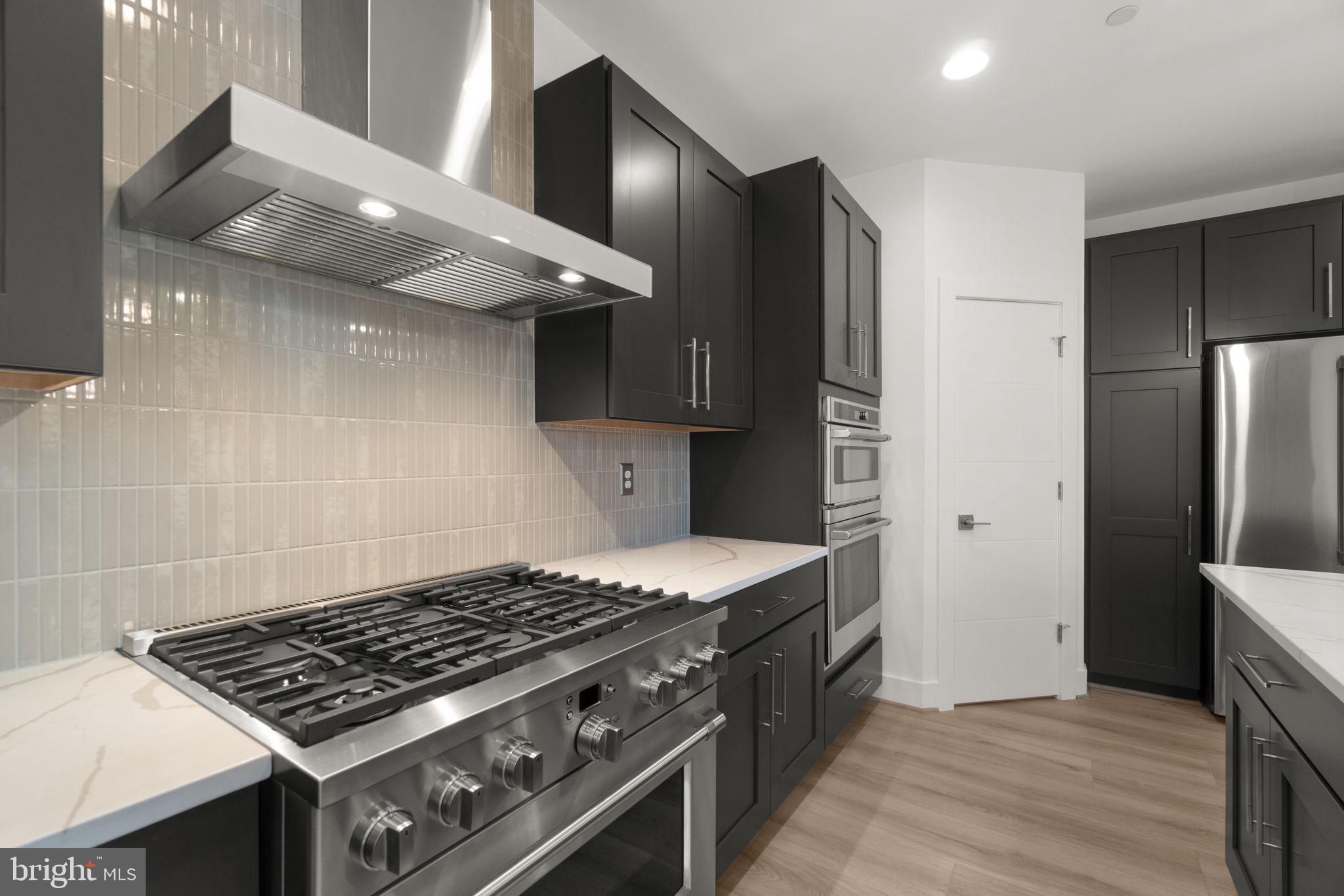14628 Old Hanover Road, Unit BENTON Reisterstown, MD 21136 - Photo 23 of 69 a stove top oven sitting inside of a kitchen